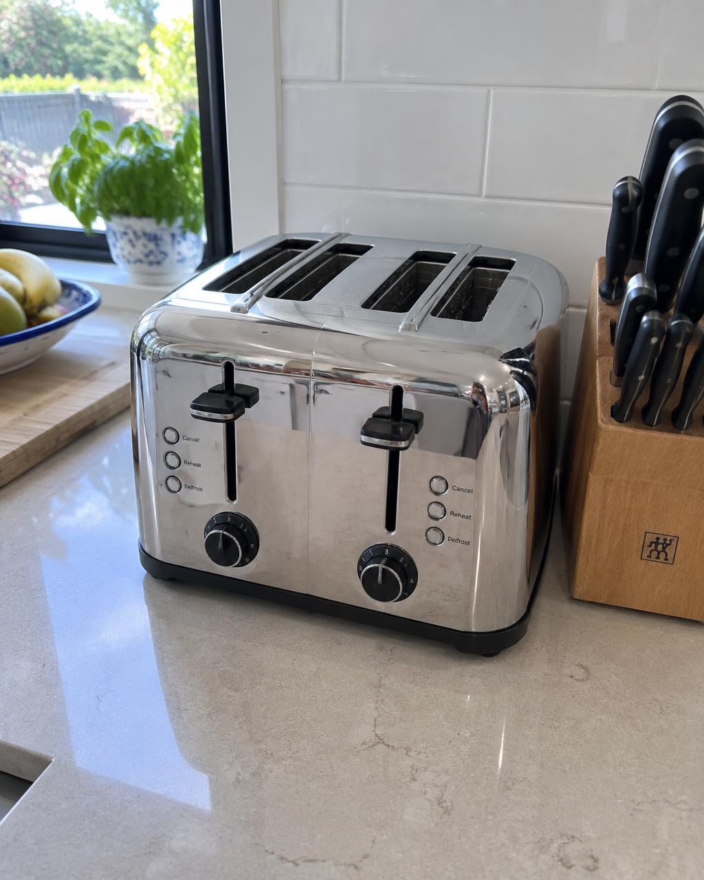 Customer photo of a polished chrome toaster on a kitchen benchtop